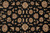 Detail of camel and cream palmettes scattered across the deep black wool pile ground