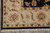 Corner of the 8x10 Indian Agra rug with ivory border, black outer band and fringe