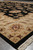 Low angle along the beige border of this black Ziegler style wool area rug