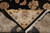 Indian hand-knotted construction revealed as the rug back folds over the black and ivory front