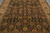 Close overhead detail of rust, olive and gold palmettes scattered across the deep black field