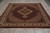 Full view of burgundy Mahi Tabriz design rug with scalloped ivory medallion and fringed cotton ends