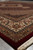 Low angle corner view highlighting the ivory main border and burgundy Herati field texture