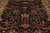 Close overhead view of indigo field with rust red palmettes, green leaves and ivory blossoms