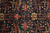 Detail of Ziegler floral vine pattern in rust, gold and sage on dark blue ground