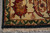Corner detail of beige border palmette, green scrolling vine and clean ivory cotton fringe ends