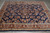 Angled overhead view showing the all over floral field and wide brick red main border