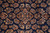 Close up of detached floral sprays and rosettes woven in cream, salmon and gold