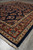 7'3" x 9'8" navy Sarough rug angled view highlighting floral field and layered borders