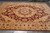 9' x 11'6" hand-knotted Zigler rug on grey tile showing burgundy central medallion