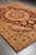 Full length view of the 9' x 11'6" burgundy and gold medallion rug on tile