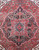 Close-up of the turquoise and black 8 point star medallion on a deep red field
