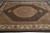 Overhead 8x11 wool and silk rug photographed flat, showing black field and ivory corner spandrels