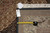 Back of the rug with inventory tag marked 8.4 x 11.3 beside a tape measure