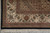 Corner close-up with black outer band, ivory floral border and clean ivory cotton fringe
