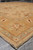 7'10" x 8'2" Pakistani Chobi rug corner and fringe at an angle on grey flooring