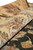 Rolled edge close-up revealing soft wool pile with rose pink and olive border detail