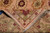 Folded corner revealing tight hand-knotted back, olive border palmette and ivory cotton fringe