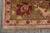 Corner detail with burgundy palmette on olive green border and peach outer guard band