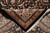 Folded corner revealing the tight knotting, low clipped pile and fine wool surface of the rug