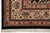 Corner detail of the beige main border with rose palmettes, paisley motifs and black edge band