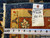 Reverse side with tag reading rug number S119, size 8.6 x 11.5, beside tape measure