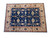 8'6" x 11'5" hand-knotted wool rug laid flat showing blue field and gold border