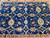Close view of indigo field with gold palmettes, ivory vine lattice and rust accent flowers
