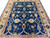Overhead studio photo of large 9x11 blue and camel area rug for living room