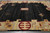 Charcoal black open field and gold border roundel seen from one end on concrete floor