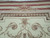 Top border detail showing brown egg and dart band above ivory field scrollwork