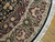 Detail of burgundy and ivory border with pink roses, green leaves and black rosette cartouches