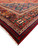 Corner detail of ivory fringe, red outer guard band and multicolored geometric border panels