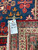 Back of the 10'1" x 13'6" rug showing even knotting, cotton foundation and tag F6985