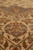 Perspective close-up of the gray corner spandrel with gold vase motif above the floral field