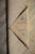 Folded back corner on stone floor revealing cotton foundation and tight hand-knotted weave