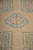Close detail of a single stepped teal diamond motif and short quarter inch pile