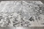 Gray and ivory abstract wool and silk rug on tile floor showing soft sheen