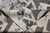 Folded corner revealing tight hand-knotted back and ivory selvage of wool silk rug