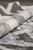 Rolled edge showing pile depth, gray banding and creamy sheen of contemporary Indian rug