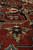 Angled close-up showing plush fine wool pile depth across black medallion and green palmette motif