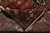 Back of 9'9" x 13'9" rug folded to show even hand-knotted weave and fringe