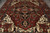 Close overhead of geometric medallion, palmettes and olive green leaf motifs on deep rust field
