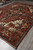 Full length angle of 9'9" x 13'9" Serapi rug showing balanced medallion and wide border