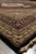 Low angle across the rug capturing sheen of silk highlights along beige guard borders