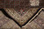 Folded corner revealing pile depth, black selvage and ivory cotton fringe on wool silk rug