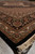 8'3" x 9'8" Indian Mahi Tabriz rug corner shown at an angle on stone flooring