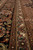 Border detail with sage green guard band, rust palmettes and black main border scrollwork