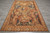 Overhead shot of the 6 x 9 Roman tapestry rug laid flat on grey tile