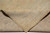 Folded back corner revealing tight knot structure and cotton foundation of this wool rug